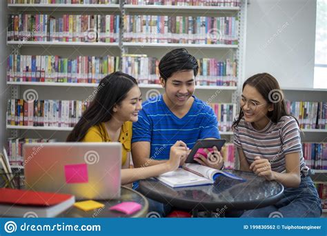 group-asian-students-smile-and-reading-a-book-and-using-the-laptop-for-students-discussing