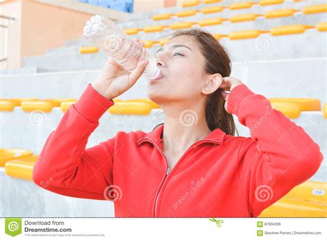 Young Women Drinking Water After Exercise Stock Photo