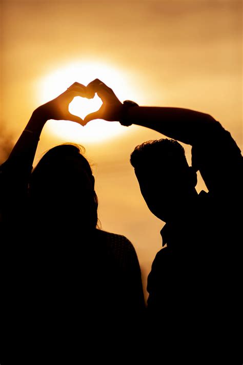 Silhouette Of Couple With Heart At Sunset · Free Stock Photo
