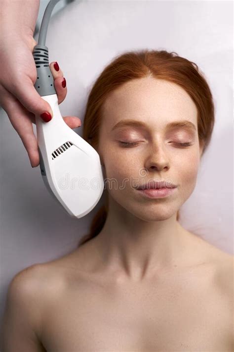 Young Female On Procedure Of Ultrasonic Cleaning Of Face Stock Photo