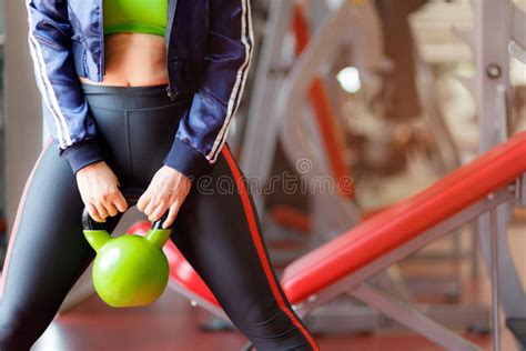 Fitness Woman Exercising Crossfit Holding Kettle Bell Weightlifting