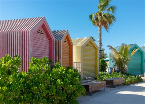 Colorful Beach Huts Near Green Trees Under Blue Sky · Free Stock Photo