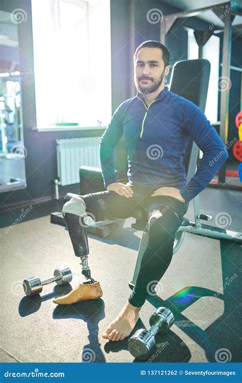 Handsome Man With Prosthetic Leg Sitting On Sport Bench Stock Photo