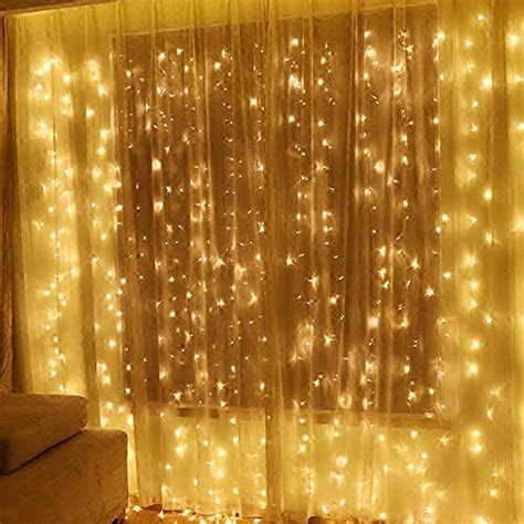 She hangs christmas lights behind her bed. Twinkle Star 600 LED Window Curtain String Light for ...