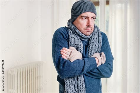 Foto De Man Feeling Cold At Home With Home Heating Trouble Do Stock
