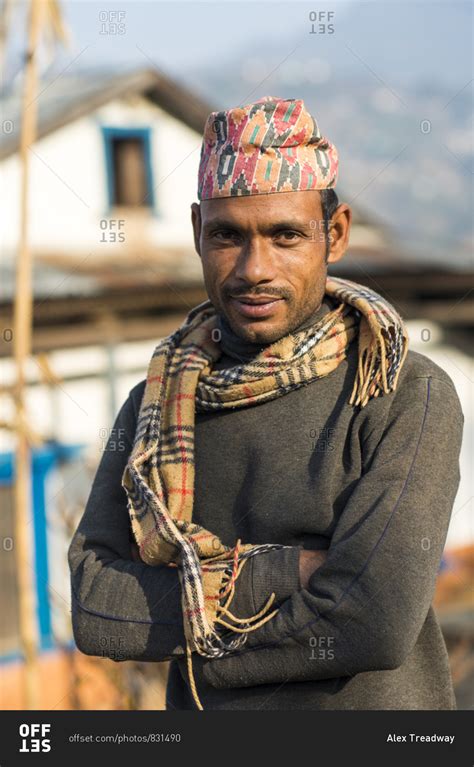 A Portrait Of A Nepali Man Wearing A Traditional Nepalese Hat Called A Topi In A Small Village