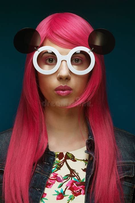 Fashion Girl With Pink Hair And Big Sunglasses Over Blue Background