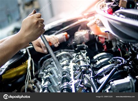 Auto Mechanic Hand Fixing Car Engine In The Garage Stock Photo By