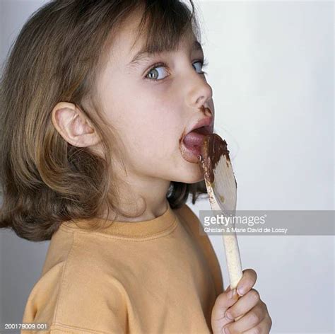 girl licking chocolate photos and premium high res pictures getty images