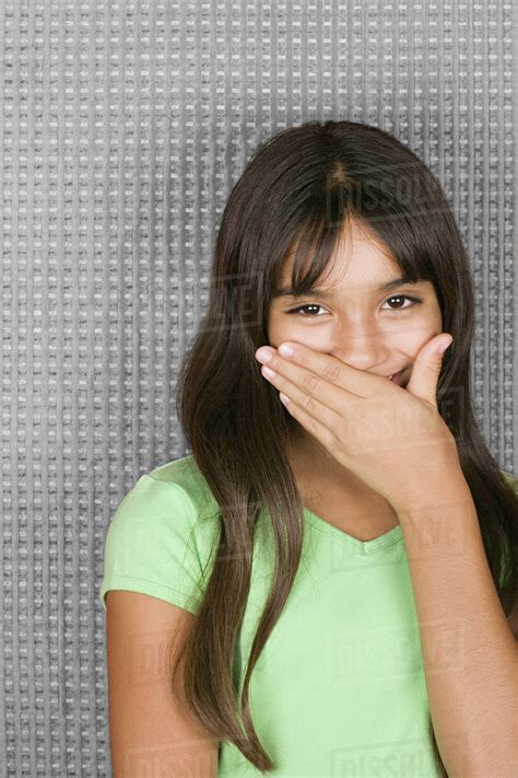 Laughing Teenage Girl With Hands Over Mouth Stock Photo Dissolve