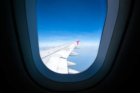 Airplane Wing On Blue Sky View Through Plane Window With Copy Space