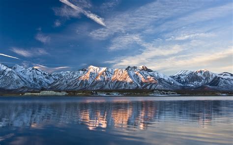 Shallow Focus Photography Of Snow Covered Mountains Near Body Of Water