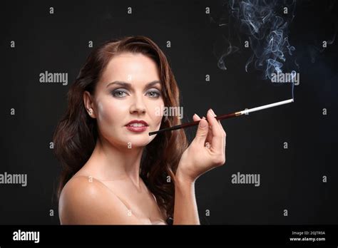Beautiful Woman Smoking Cigar On Dark Background Stock Photo Alamy
