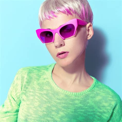 Premium Photo Blonde With A Fashionable Hairstyle And Pink Glasses
