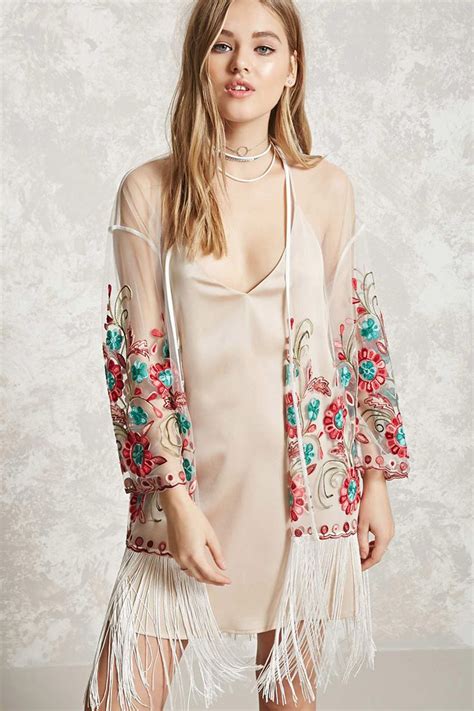 A Sheer Mesh Kimono Featuring Floral Embroidery A Fringed Hem Scalloped Edges And An Open