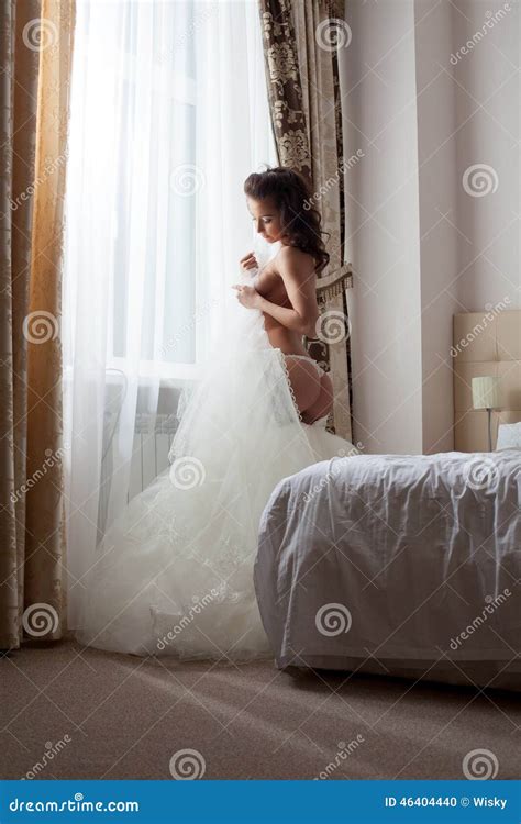 Bride Undressing In Hotel Room Stock Photo Image