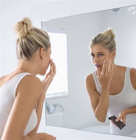 Woman Looking In The Mirror Trying To Look Younger Spray Tan Solution