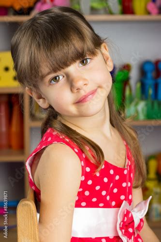 6 Years Old Girl Blond Hair Red Dress With White Polka Dots Stock