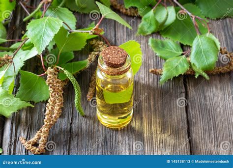 A Bottle Of Birch Essential Oil With Birch Branches Stock Image Image