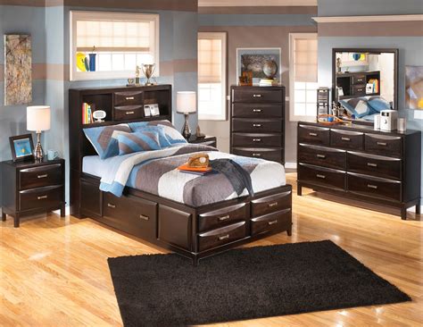 Crafted from solid and manufactured wood, the bed features linen upholstery for an inviting feel, while a gray wash hue offers up some aged appeal. Kira Youth Storage Bedroom Set from Ashley (B473 ...