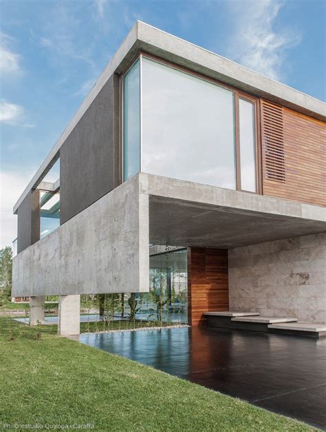 Exposed Concrete And Glass House On A Beautiful Lake Shore