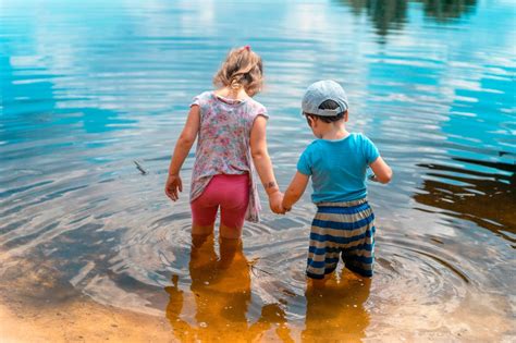 Little Children Stand In The Water Of The River Free Stock Photo