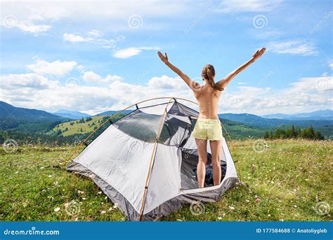 Woman Tourist Hiking In Mountain Trail Enjoying Summer Sunny Morning In Mountains Near Tent