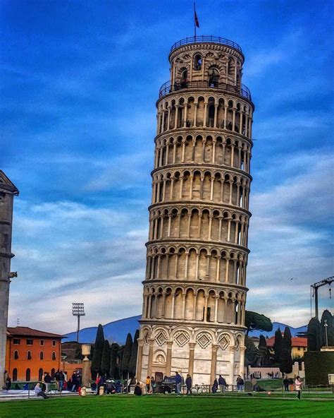 The Leaning Tower Of Pisa In Italy Against A Blue Sky