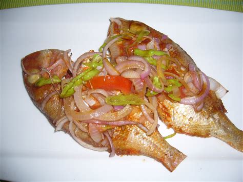 Common staple foods include grains and tubers. INDIAN FOOD: Roasted fish (Ivorian style)