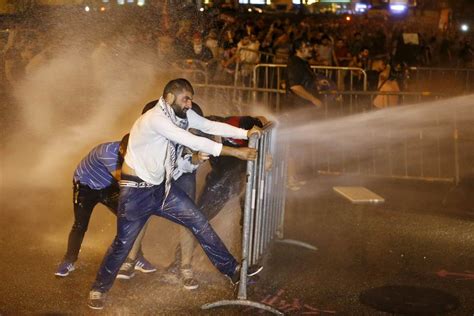 PHOTOS Police Fire Tear Gas Water Cannons At Lebanese Protesters