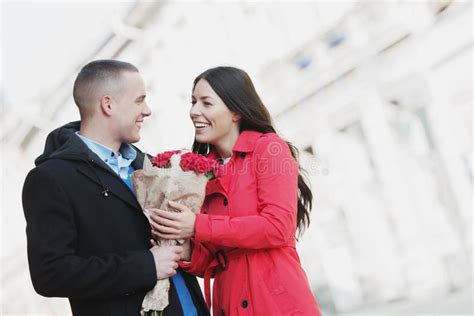Man Giving Flowers To His Girlfriend Young Romantic Couple Outdoors