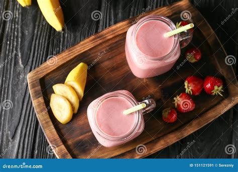 Mason Jars With Tasty Strawberry Smoothie And Banana On Dark Table Stock Image Image Of Board