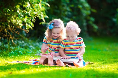 Последние твиты от lecsy bush(@lecsy_lexy). Two Kids Reading In Summer Garden Stock Image - Image of ...