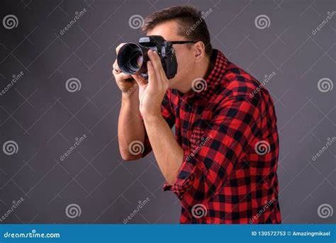 Portrait Of Young Handsome Man Photographer Holding Camera Stock Image
