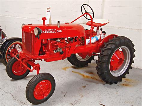An Old Red Farmall Tractor Parked In A Garage