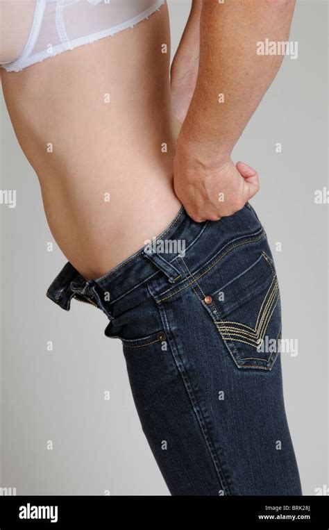 Woman Pulling Up Her Blue Jeans Stock Photo Alamy