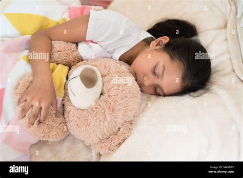 Young Little Asian Girl Sleeping While Hugging Teddy Bear Sleep