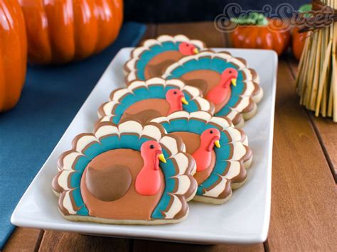 Decorated Turkey Cookies On A White Plate With Pumpkins In The Backgroung