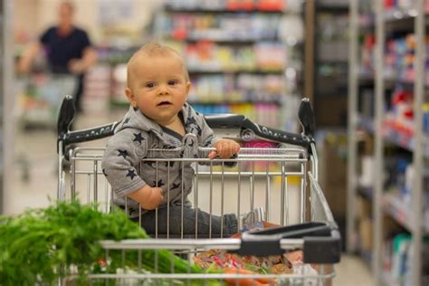 Toddler Baby Boy Sitting In A Shopping Cart In Grocery Store S Stock