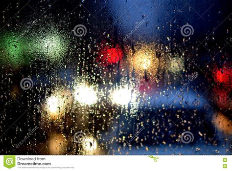 Rain Drops On Window And Blurred Traffic Lights Background Stock Image