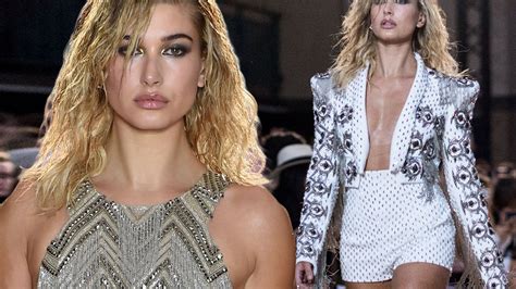hailey baldwin risks nip slip in plunging outfit as she hits lfw catwalk in front of star guests