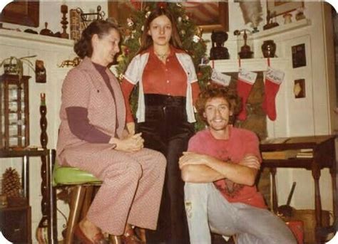 Three Women Sitting Next To Each Other In Front Of A Christmas Tree