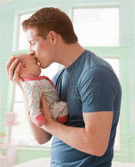 Caucasian Father Kissing Baby Girl Stock Photo Dissolve