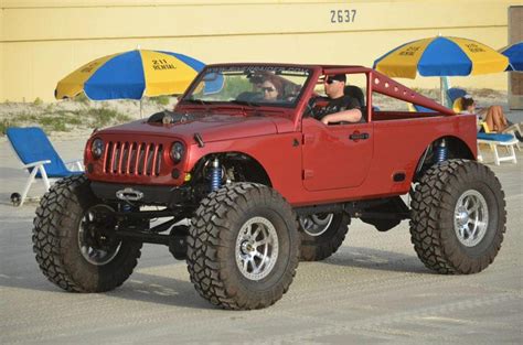 A Red Jeep With Two People In It