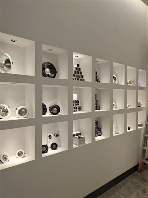 A White Wall Filled With Lots Of Different Types Of Plates On Shelves