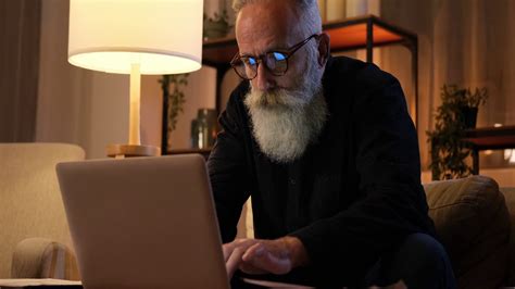 Senior Man Working On Laptop Late Night Stock Video