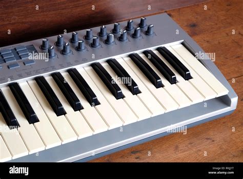 Electronic Synthesizer Keyboard With Many Control Knobs In Silver