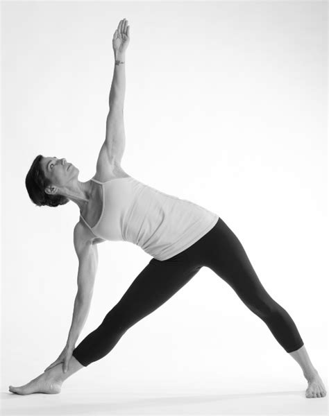 A Woman In A Yoga Pose With Her Arms Stretched Out And Legs Bent
