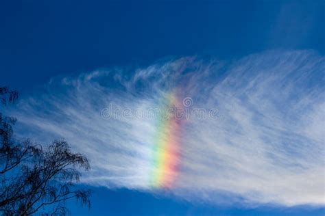 A Rainbow Cloud Against A Blue Sky A Rare Optical Phenomenon In The