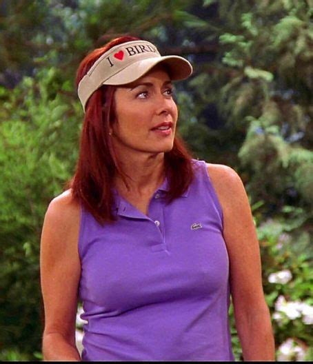 A Woman Wearing A Purple Shirt And A Hat With I Love Golf Written On It